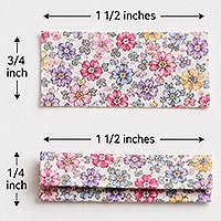 Two floral fabric strips measuring 1 inches by inch, with one strip folded into thirds, illustrating how to prepare the shoulder straps for a doll pin doll dress.
