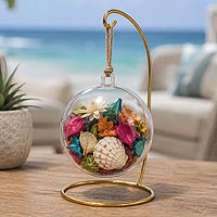Beach-inspired fillable ornament potpourri craft idea featuring seashells, dried flowers, and home d�cor accents for year-round decorating.
