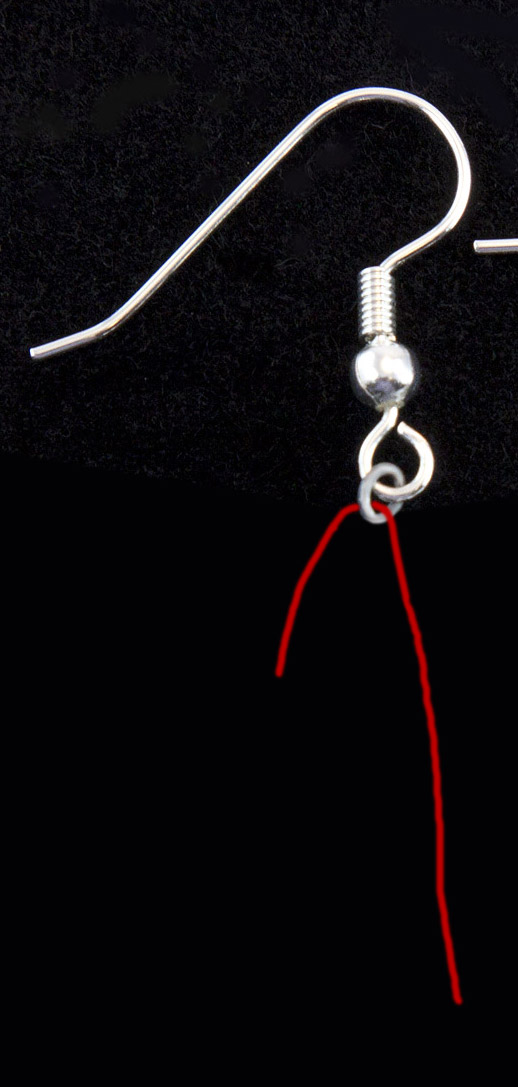 Inserting the wire into the earrings.