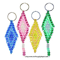Four diamond-shaped keychains woven from translucent pony beads in blue, pink, yellow, and green, with two designs featuring contrasting center patterns and beaded dangles.