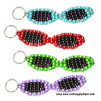 Colorful pony bead sunglasses keychain made with purple and black pony beads attached to a keyring.